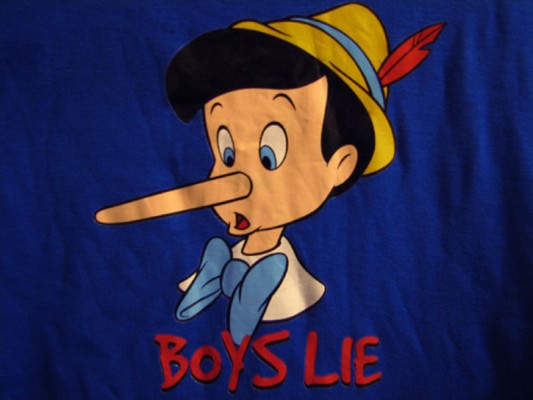 detail of a t-shirt with a silkscreen printed image of Pinocchio and the text "Boys Lie"
