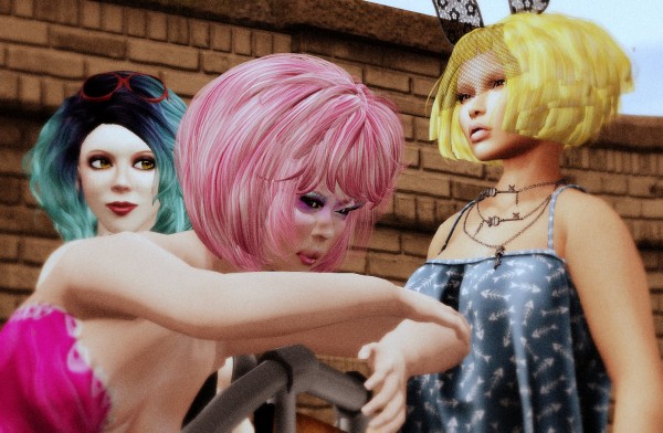 Photo of Vanessa Blaylock, Oh My Geisha, & Scarlett Luv. Blaylock's hair is dyed ombre blue, Geisha is in pink hair and Luv in a golden-yellow color.  All 3 have short, yet big, bob haircuts