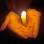 photo of hands holding a candle