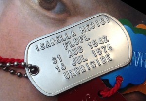 photo of a dog tag that reads "Isabella Medici, FLOFL, 31 Aug 1542, 16 Jul 1576, Uxoricide. 